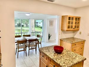 a kitchen with a table and a dining room at Newly remodeled 2br, 2ba condo in Naples Bath and Tennis in Naples