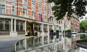 a building on a street with a reflection in the water at Exclusive Lux Central London Apartment Sleeps 4 in London