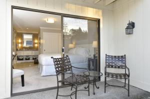 a bedroom with a bed and a table and two chairs at High-end Getaway Suite at Silverado in Napa