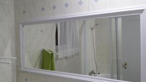 a mirror in a bathroom with a shower at Varanda do Atlântico in Ponta Delgada +23 photos