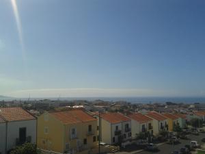 a view of a city with houses and the ocean at Varanda do Atlântico in Ponta Delgada
