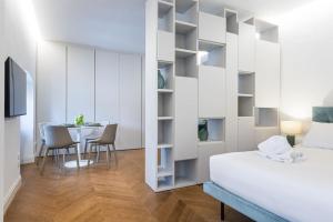 a bedroom with a bed and a table with chairs at UNYCA - Duomo Luxury View Florence in Florence