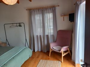 a bedroom with a bed and a chair and a mirror at Pavlos Loft - Garden Views & Terrace in Leontari in Leondárion
