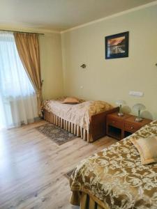 sypialnia z 2 łóżkami i oknem w obiekcie Pensjonat Rehabilitacyjno-Rekreacyjny Zagórzanka w Mszanie Dolnej