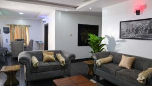 a living room with two couches and a table at BOL LODGE AND APARTMENT in Lagos