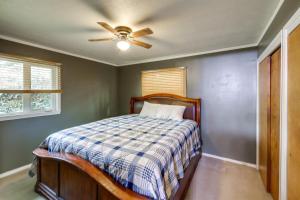 a bedroom with a bed with a ceiling fan at Pet-Friendly Montana Abode with Balcony and Fireplace! in Stevensville