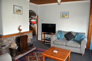 a living room with a couch and a fireplace at Meadowsweet in Skegness