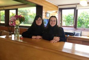two women sitting at a table in a restaurant at Hotel Germania in Puerto Varas
