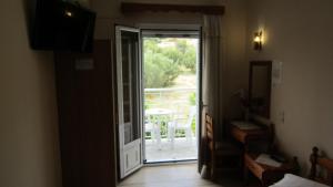 an open door leading to a balcony with a view at Sandalis Hotel in Pythagoreio +56 photos