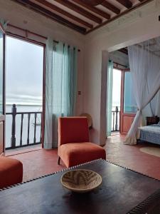 a living room with a view of the ocean at Pwani House - Lamu Seafront in Lamu