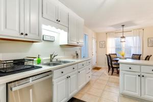 a kitchen with white cabinets and a sink at Spacious Madison Vacation Rental with Backyard! in Madison