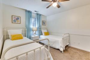 a bedroom with two beds and a ceiling fan at Spacious Madison Vacation Rental with Backyard! in Madison
