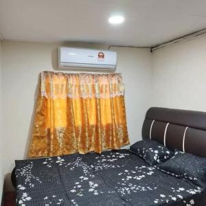 a bedroom with a bed and a window in a trailer at Kubang Sepat HomeStay in Ayer Hitam