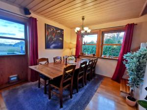 a dining room with a wooden table and chairs at Mikael's Bed & Spa apartment in Sandefjord