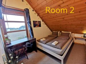 a bedroom with a bed in a room with a window at Mikael's Bed & Spa apartment in Sandefjord