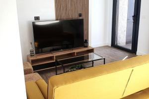 a living room with a large flat screen tv at Apartamento A Cachola in Cangas de Morrazo