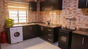 a kitchen with a washing machine and a washer at BOL LODGE AND APARTMENT in Lagos
