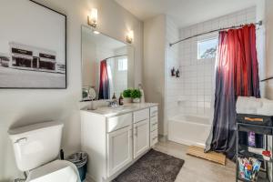 a bathroom with a toilet and a sink and a tub at Radiant condo on the Riverwalk 1325 in San Antonio