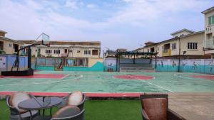 una cancha de baloncesto vacía con sillas y un aro de baloncesto en BOL LODGE AND APARTMENT en Lagos