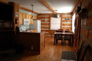 a kitchen and dining room with a table and chairs at Whiskey Run Cabin, Spectacular Mountain Views in Bryson City