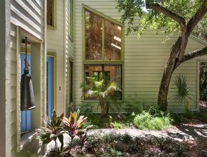 a house with a window and plants in front of it at Beach Paradise Getaway - 200ft from Beach! in Sebastian