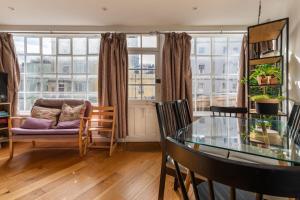 a living room with a glass table and a couch at Bright & Quirky 3BD Home - Wellington Terrace! in Bristol