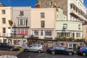 a group of cars parked in front of buildings at Bright & Quirky 3BD Home - Wellington Terrace! in Bristol