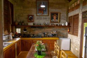 a kitchen with a table and a refrigerator and a sink at Rincones del Mogote 