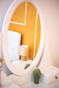 a round mirror in a room with a lamp at Isabel Apartaments Old Town in Padova