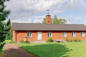 a brick house with a chimney on top of it at Bonäs bygdegård in Mora