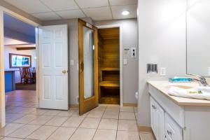 a kitchen with a door leading to a dining room at Lake Placid Club Lodges in Lake Placid