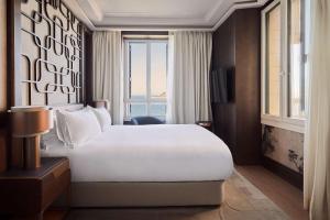 a hotel room with a large bed and a window at Nobu Hotel San Sebastián in Donostia-San Sebastián