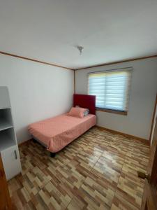 a small bedroom with a bed and a window at cabañas san antonio in Los Ángeles +15 photos