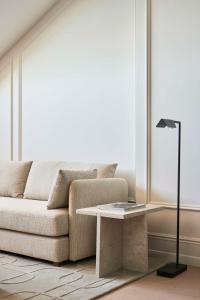 a living room with a couch and a table at Nobu Hotel San Sebastián in Donostia-San Sebastián