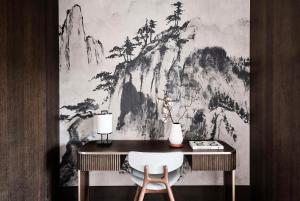 a desk with a white chair and a wall mural at Nobu Hotel San Sebastián in Donostia-San Sebastián