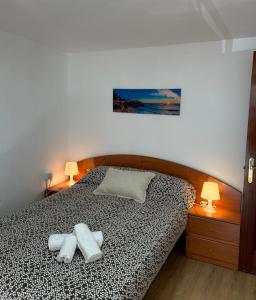 a bedroom with a bed with two towels on it at Mediavilla in Aller