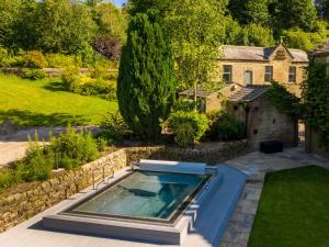 a swimming pool in the yard of a house at Moorlands Manor in Colne