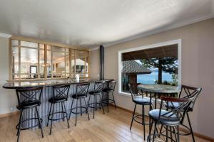 a kitchen with a bar with stools and a window at Tahoe Lakescape in Zephyr Cove
