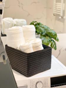 a basket of towels sitting on a counter at Emerald Apartment in Arad