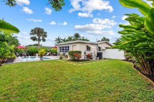 a house with a yard and a pool at Wilton Manors Oasis with an outdoor Pool in Fort Lauderdale