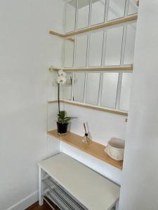 a white room with a white bench and a window at appartement in Vitry-sur-Seine