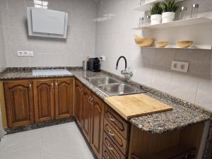 a kitchen with a sink and a counter at Casa Pagan in Cullera