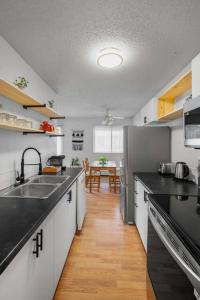 a kitchen with a sink and a counter top at Downtown 1BR Top Floor with View Free Parking in Fort McMurray