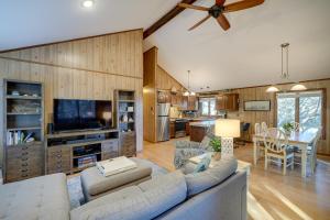 a living room with a couch and a tv at Outer Banks Retreat - Walk to Beach! in Southern Shores