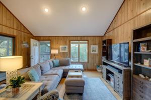 a living room with a couch and a tv at Outer Banks Retreat - Walk to Beach! in Southern Shores