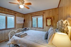 a bedroom with a white bed with a ceiling fan at Outer Banks Retreat - Walk to Beach! in Southern Shores