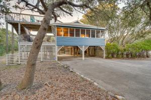 a house with a blue roof and a tree at Outer Banks Retreat - Walk to Beach! in Southern Shores
