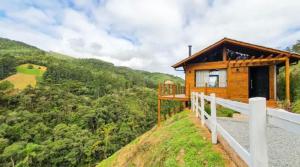 une cabane en bois sur une colline avec vue dans l'établissement Chalé Canto da Montanha, à Annitapolis