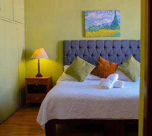 a bedroom with a large bed with a blue headboard at CASA MARFIL in Lagos de Moreno