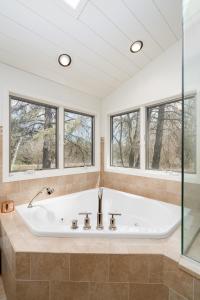 a bath tub in a bathroom with windows at Riverfront Inn in Red Wing